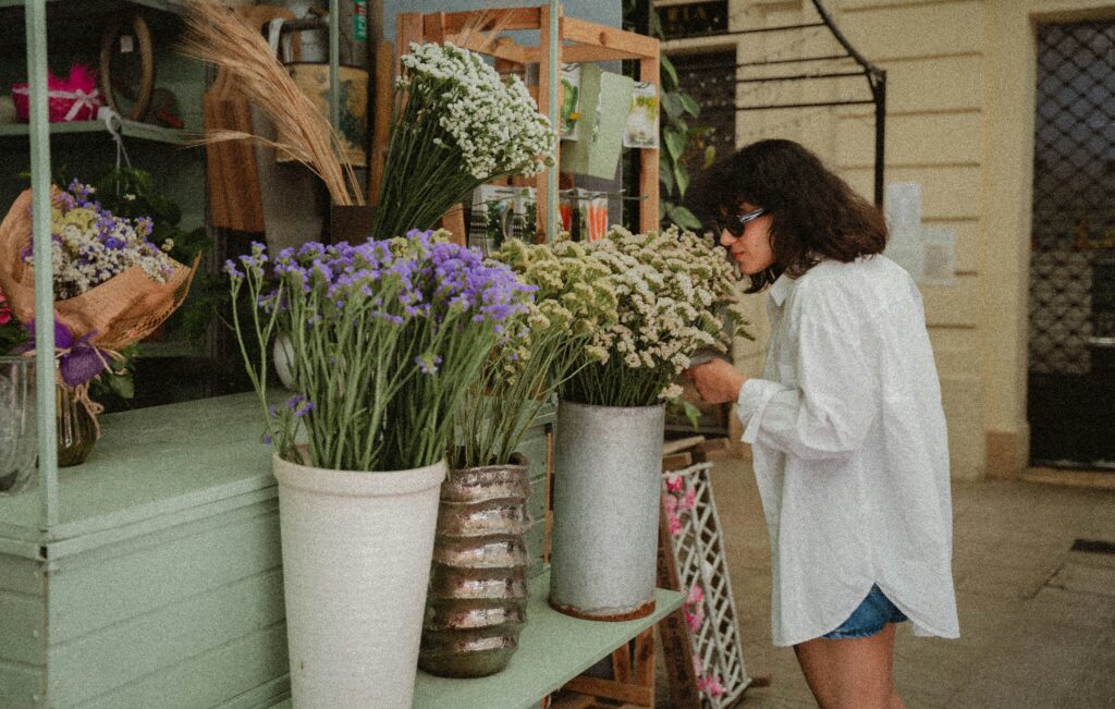 Woman smelling and shoping for flowers